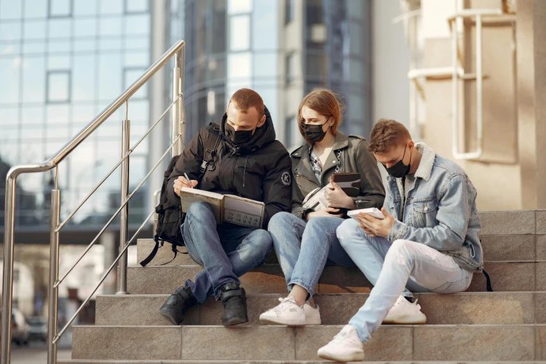 a group of people sitting on the steps of a building, some of them use gask mask, studious, studying, profile image