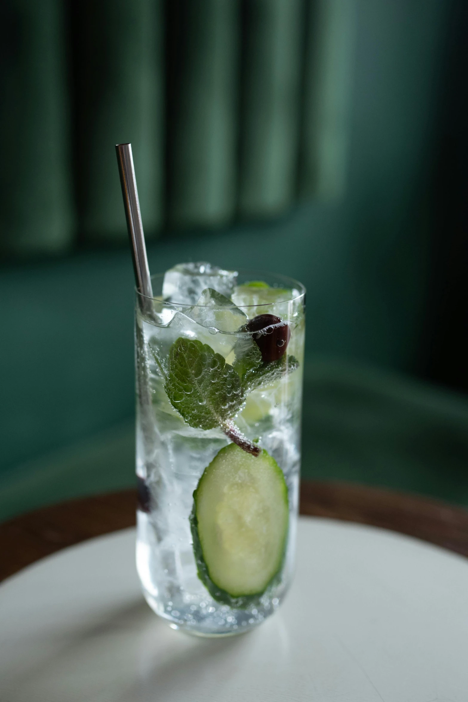 a glass of water with cucumber and mint, inspired by Ndoc Martini, mixed animal, highly polished, 1 9 0 0 s, silver mist