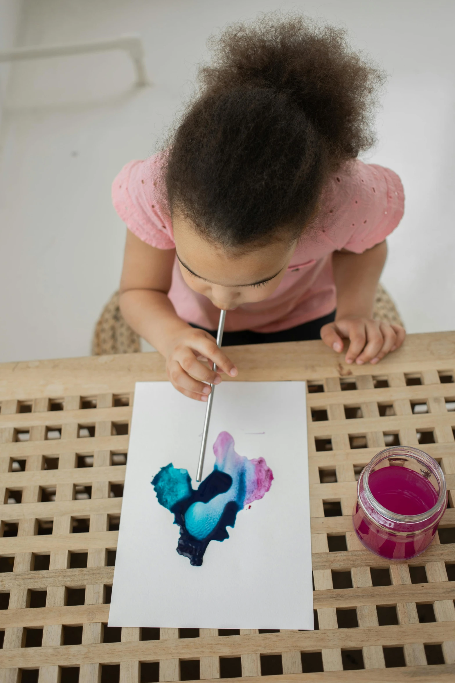 a little girl is painting on a piece of paper, inspired by Helen Frankenthaler, fluid smoke art, hearts, full product shot, deep ink colors