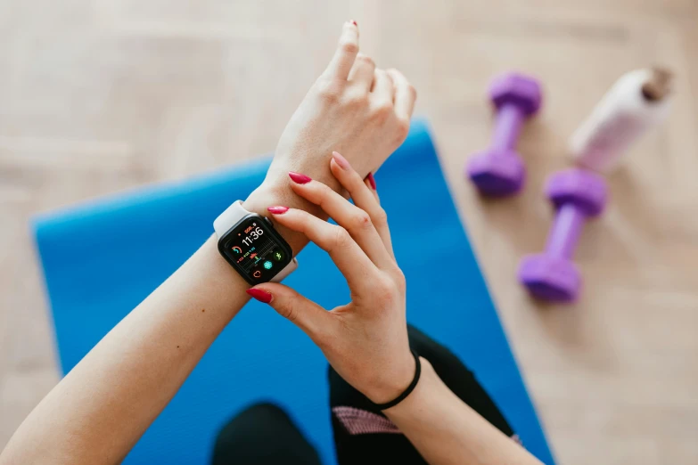 a close up of a person holding an apple watch, a cartoon, by Julia Pishtar, trending on pexels, background a gym, square, yoga, set photo