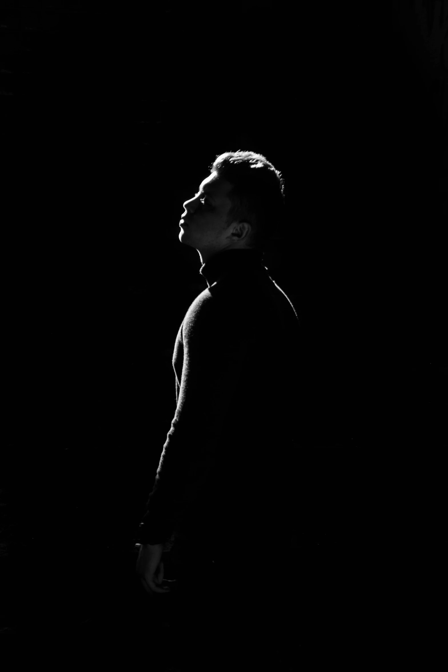 a black and white photo of a man in the dark, a black and white photo, by Max Dauthendey, minimalism, zayn malik, backlit!!, muhammad ali, alternate album cover