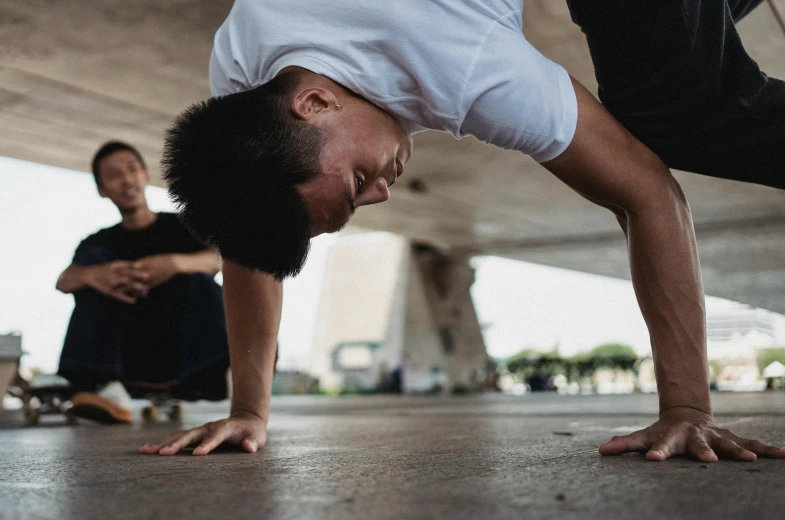 a man doing a handstand on a skateboard, pexels contest winner, ruan jia and brom, looking across the shoulder, dance meditation, they are crouching