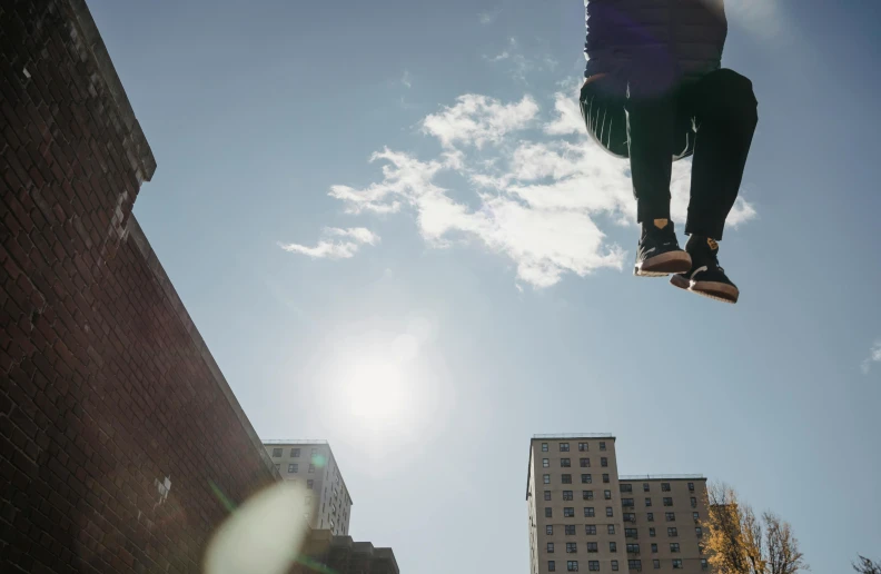 a man flying through the air while riding a skateboard, by Niko Henrichon, pexels contest winner, realism, giantess, sunny day, unsplash 4k, multiple stories