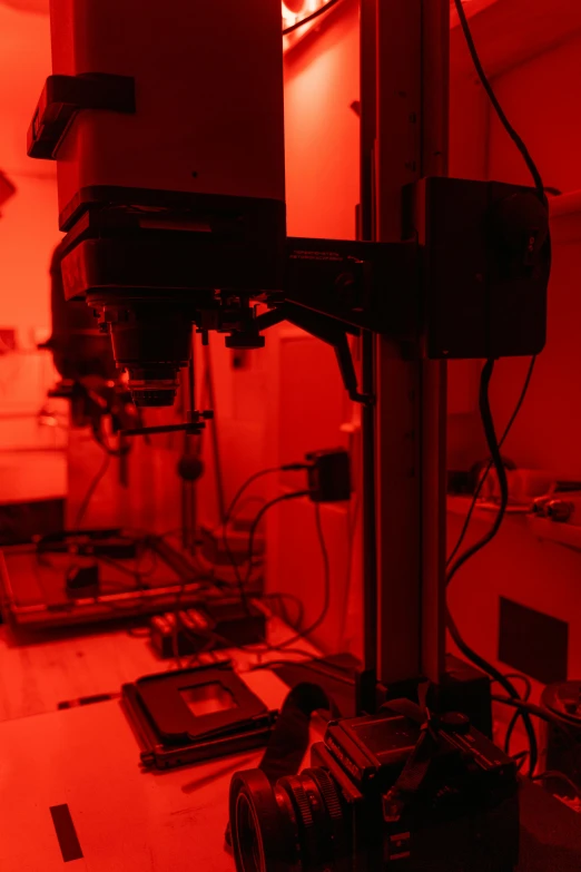 a computer sitting on top of a table under a red light, a microscopic photo, in a laboratory, darkroom, slide show, aesthetics
