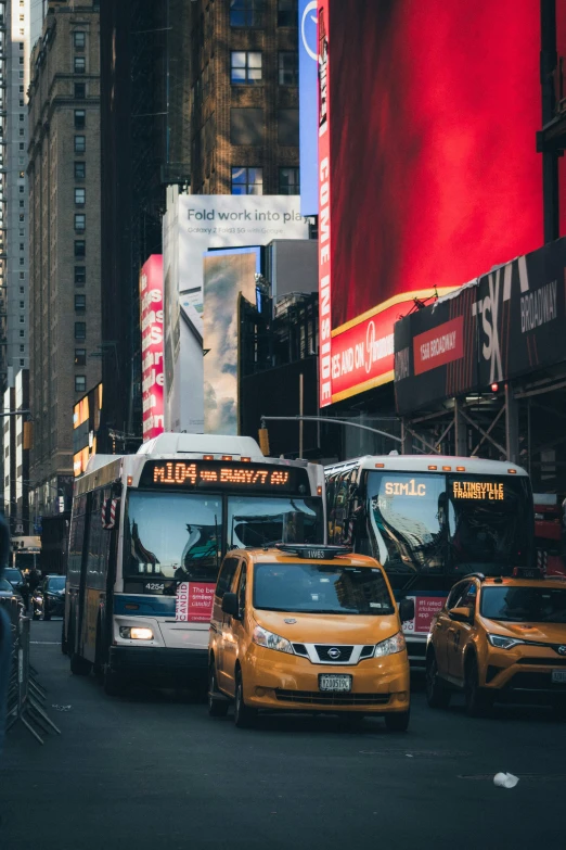 a city street filled with lots of traffic next to tall buildings, by Micha Klein, pexels contest winner, happening, bus stop, new york background, square, commercial banner