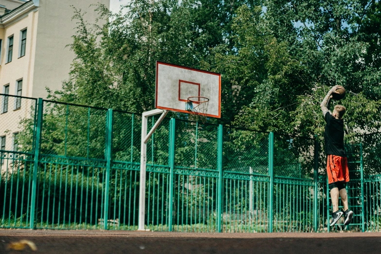 a man standing on top of a basketball court holding a basketball, inspired by Elsa Bleda, featured on dribble, portra 800 street photography, a green, knyazev konstantin, 15081959 21121991 01012000 4k