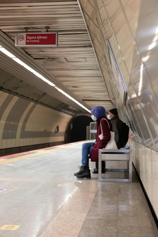 a person sitting on a bench in a subway station, by Washington Allston, two people, e-girl, chile, 8 k )