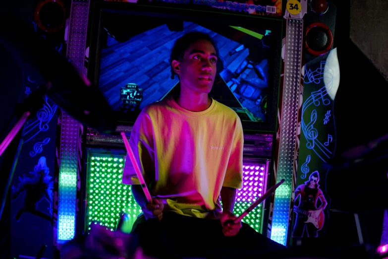 a man playing drums in a dark room, inspired by Liam Wong, interactive art, dive bar with a karaoke machine, avatar image, hyper color photograph, actor