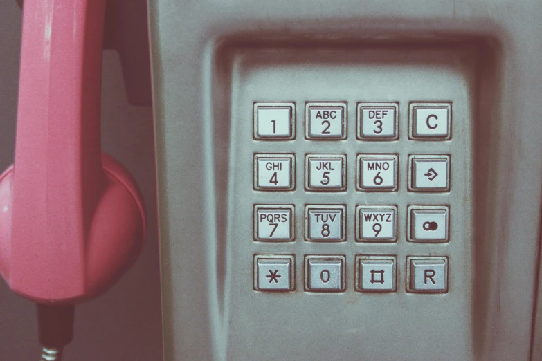 a pink phone sitting on top of a table, by Elsa Bleda, trending on pexels, art nouveau, teal silver red, numerical, 1 9 8 0 s photo, square