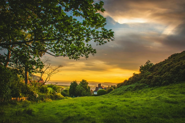 a lush green field under a cloudy sky, by Julian Hatton, pexels contest winner, romanticism, sunset light, holywood scene, tourist photo, youtube thumbnail