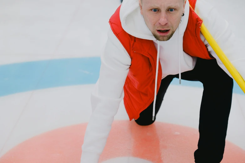 a man holding a curling stick on top of a curling rink, inspired by Sven Nordqvist, pexels contest winner, white, profile image, 1 4 9 3, thumbnail