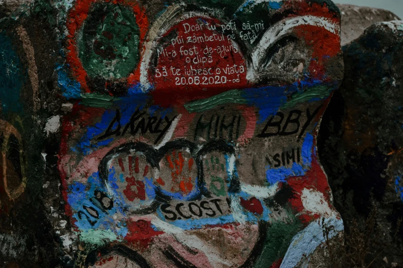 a red fire hydrant sitting next to a wall covered in graffiti, an album cover, flickr, cave paintings, background image, london south bank, may 6 8