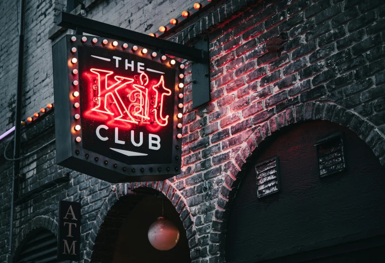 a neon sign hanging from the side of a brick building, kitsch movement, big wooden club, the cat in the hat, kali, avatar image