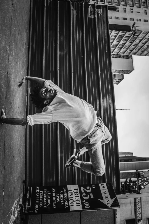 a man flying through the air while riding a skateboard, a black and white photo, pexels contest winner, conceptual art, donald glover as miles morales, on a wall, classic dancer striking a pose, in sao paulo