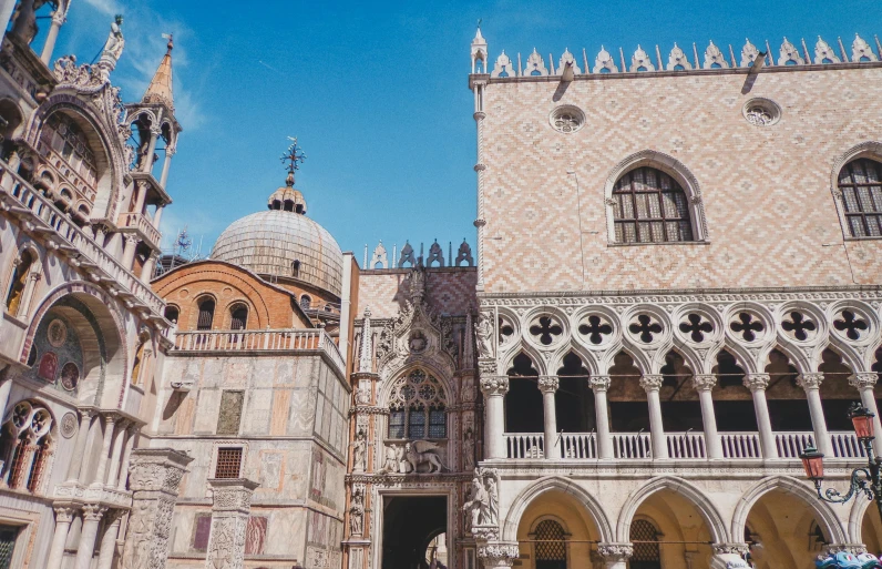 a group of people standing in front of a building, inspired by Quirizio di Giovanni da Murano, pexels contest winner, baroque, square, moorish architecture, view from the ground, ornate retreat