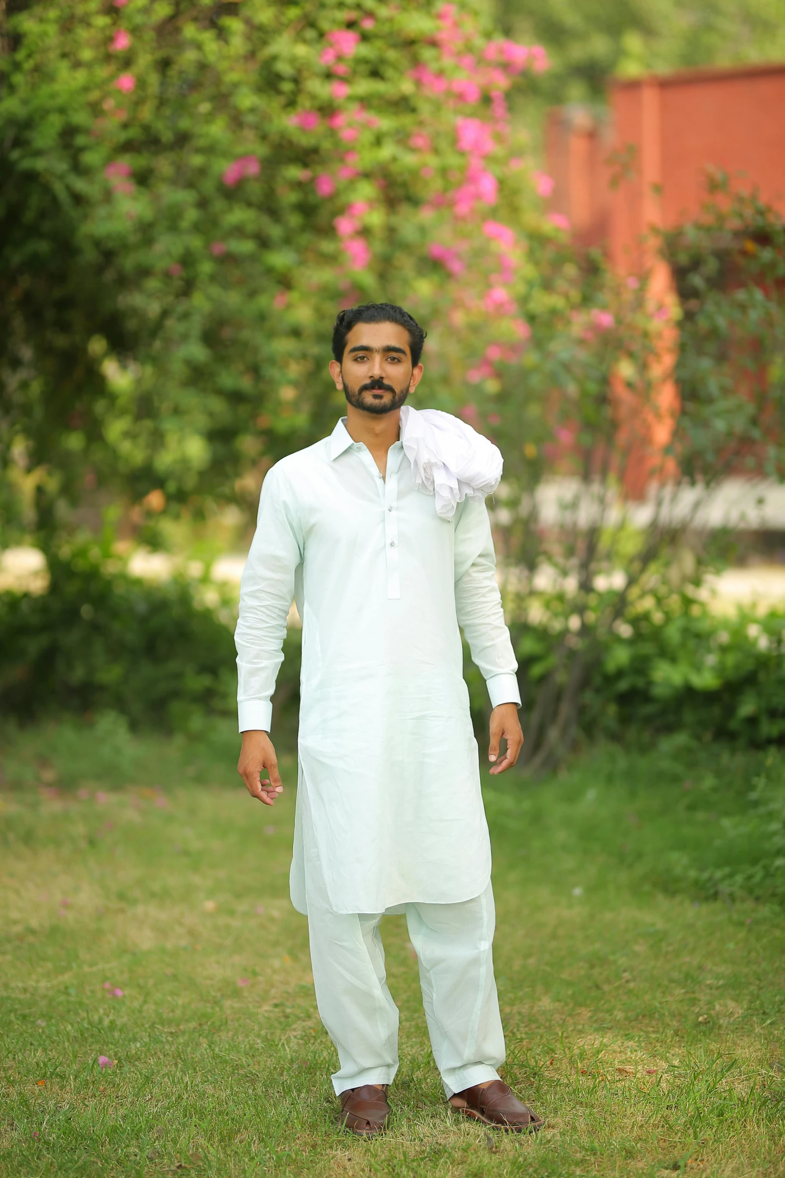 a man standing on top of a lush green field, a portrait, by Riza Abbasi, renaissance, wearing white pajamas, with mustache, linen, ready to model