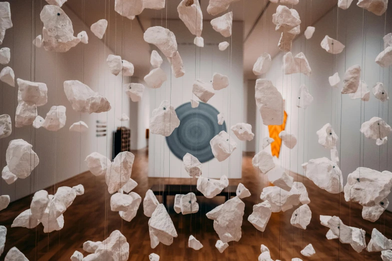 a room filled with lots of white rocks hanging from the ceiling, a marble sculpture, by Lee Loughridge, pexels contest winner, interactive art, in an art gallery], floating symbols and crystals, saatchi art, lachlan bailey