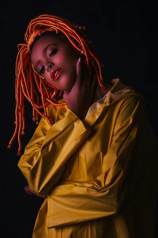 a woman with dreadlocks posing for a picture, an album cover, inspired by Afewerk Tekle, trending on pexels, afrofuturism, orange glowing hair, yellow clothes, dramatic lowkey studio lighting, a redheaded young woman