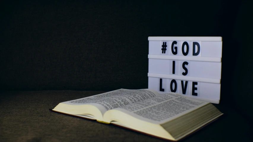 an open book sitting on top of a table, god like, loverslab, in white lettering, profile image