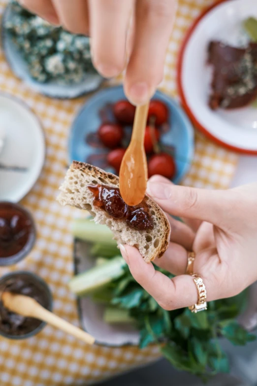 a person holding a spoon over a piece of bread, dau-al-set, dripping bbq sauce, sunday afternoon, healthy, lulu chen