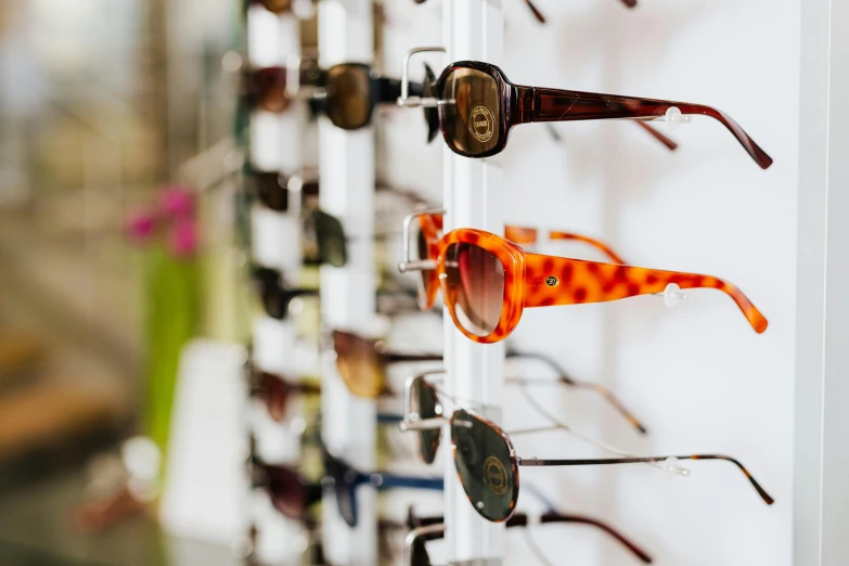 a rack with many pairs of sunglasses on it, unsplash, square rimmed glasses, 🦩🪐🐞👩🏻🦳, beauty shot, premium quality