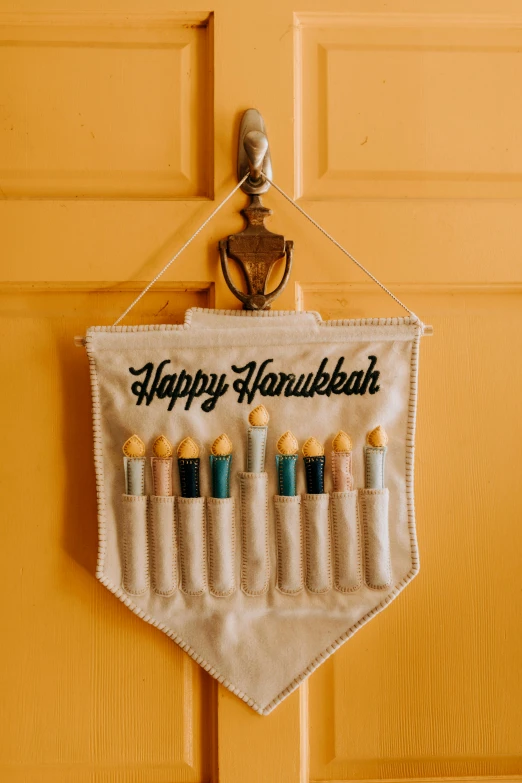 a happy hanukah banner hanging on a door, by Helen Berman, pexels, folk art, holster, lit with candles, 1 6 x 1 6, instagram story