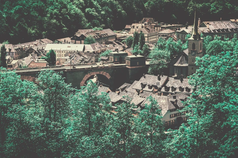 an aerial view of a town surrounded by trees, inspired by Thomas Struth, pexels contest winner, renaissance, desaturated, mill, green, brown
