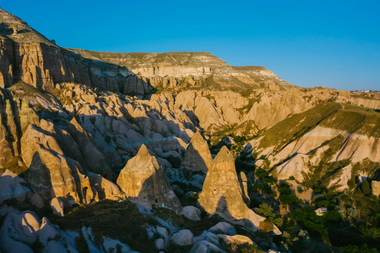 a group of people standing on top of a mountain, pexels contest winner, art nouveau, chiseled formations, dappled in evening light, turkey, youtube thumbnail