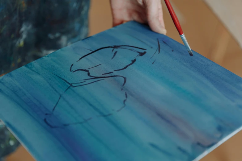 a close up of a person holding a brush and a painting, inspired by Charles Blackman, pexels contest winner, penned in cyan ink, drawing 4k, drawn with a single line, painting on silk