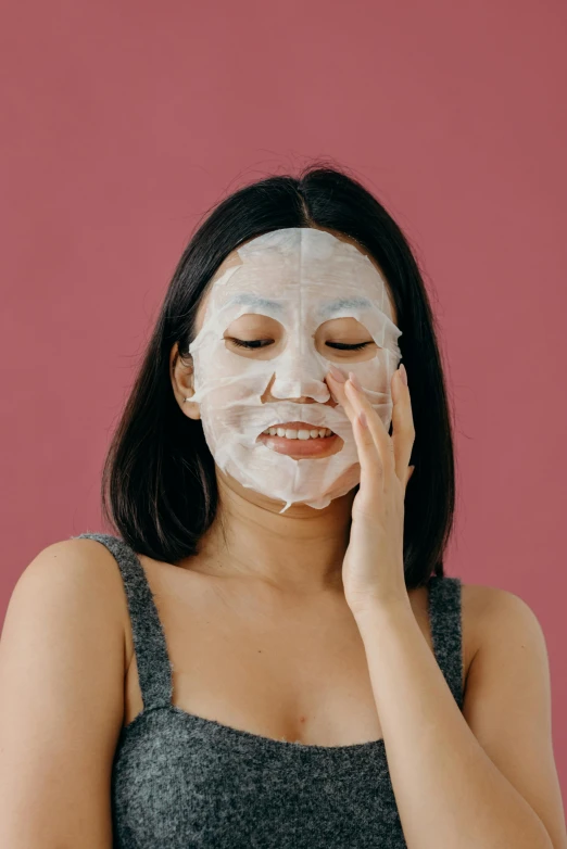 a woman with a sheet mask on her face, trending on pexels, on clear background, asian hyperdetailed, having a good time, frontal picture