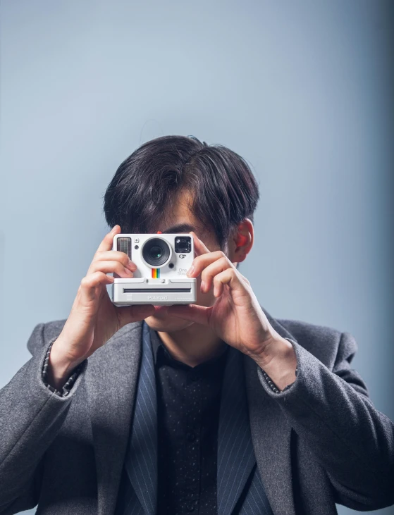 a man taking a picture with a polar camera, a polaroid photo, inspired by Kanō Naizen, unsplash, asian man, slightly pixelated, professional photo-n 3, lovingly looking at camera