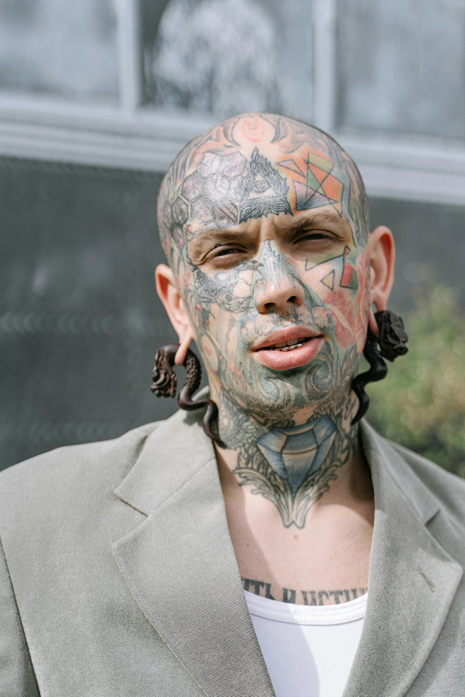 a man with a lot of tattoos on his face, inspired by Seb McKinnon, trending on pexels, renaissance, hybrid human/tank, gangster, zoomed out, brett goldstein