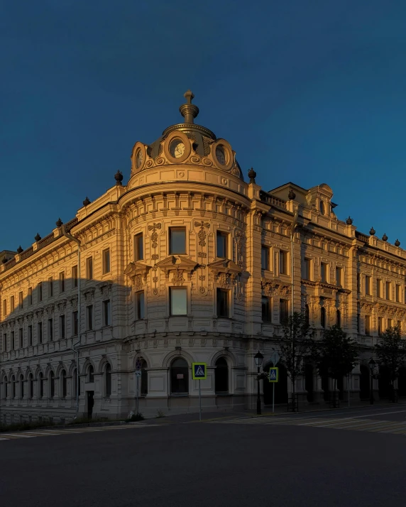 a large building with a clock on the top of it, during a sunset, profile image