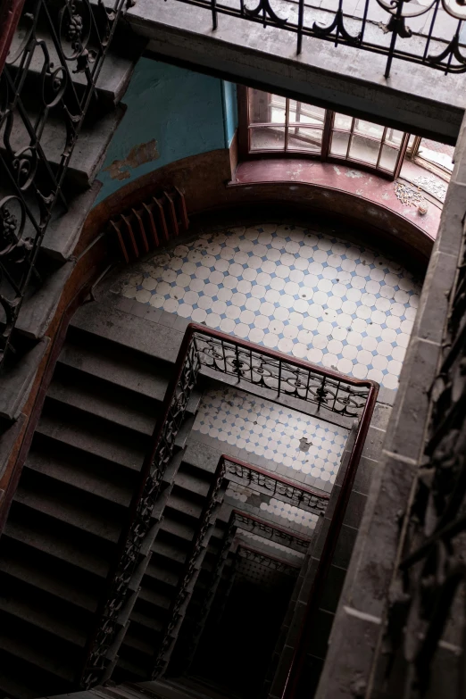 a spiral staircase in a building with wrought railings, inspired by M.C. Escher, unsplash contest winner, baroque, color”, “derelict architecture buildings, mexico city, high angle