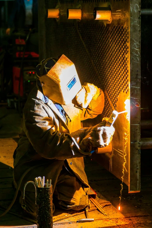 a welder working on a piece of metal, coper cladding, thumbnail, peter marlow photography, square