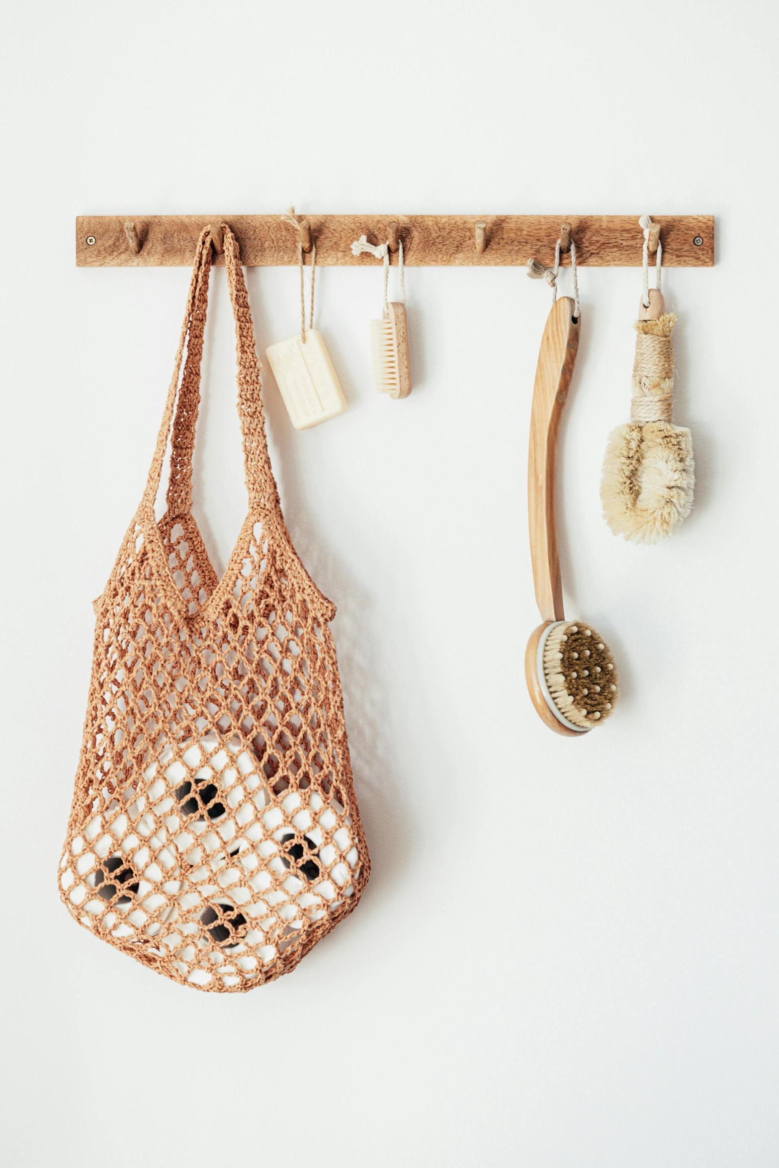 a close up of a bag hanging on a wall, poster art, by Jessie Algie, unsplash, washy brush, crochet skin, a wooden, shopping groceries