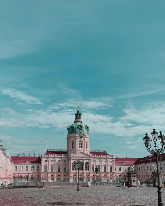 a large building with a clock tower on top of it, pexels contest winner, baroque, pink and teal, berlin park, lgbtq, 🚿🗝📝