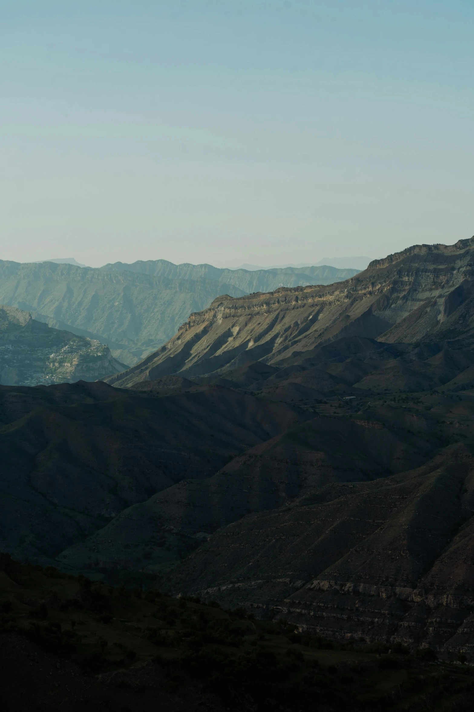 a person flying a kite on top of a mountain, les nabis, layers of strata, late summer evening, canyons, panoramic