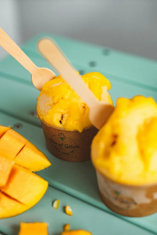 a couple of cups filled with ice cream and mango slices, cam de leon, organic, thumbnail, kano)