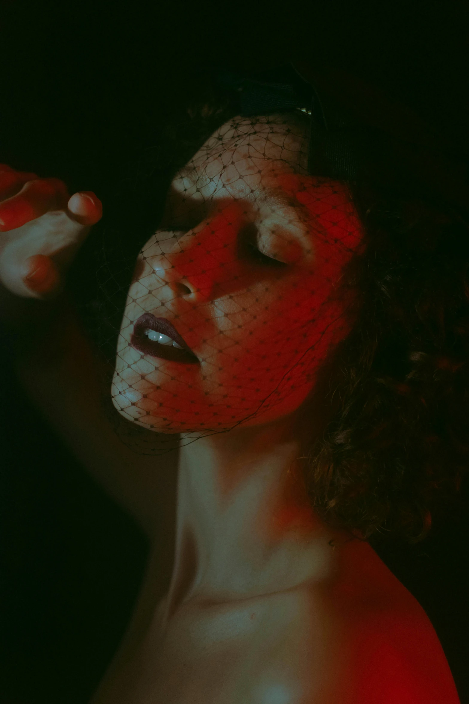 a woman with a red light on her face, an album cover, inspired by Elsa Bleda, renaissance, in rapture, netting, low quality photo, seducing