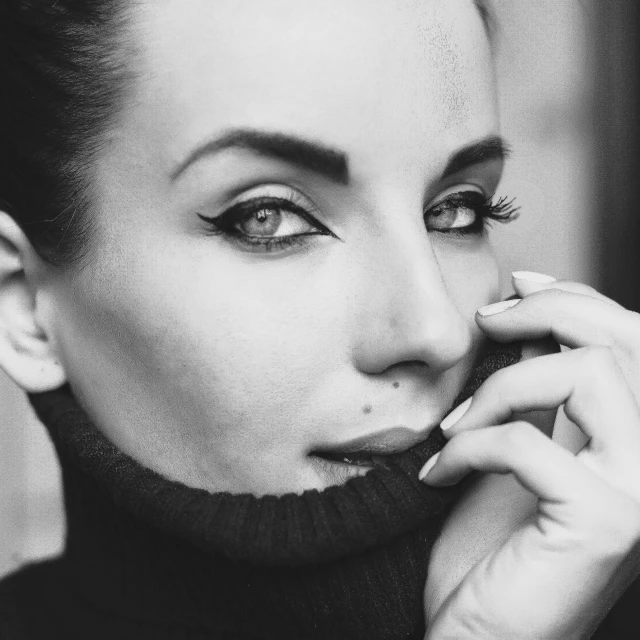 a black and white photo of a woman talking on a cell phone, a black and white photo, inspired by Evaline Ness, trending on pexels, extreamly beautiful eyes, wearing turtleneck, olga buzova, very beautiful angeline jolie