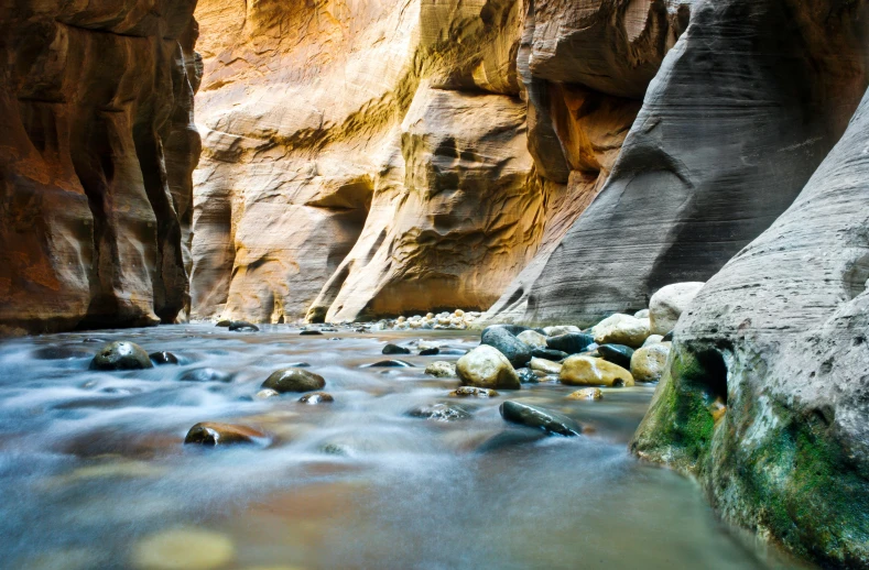 a river flowing through a narrow canyon filled with rocks, unsplash contest winner, hurufiyya, fan favorite, panels, sandstone, shimmering iridescent water