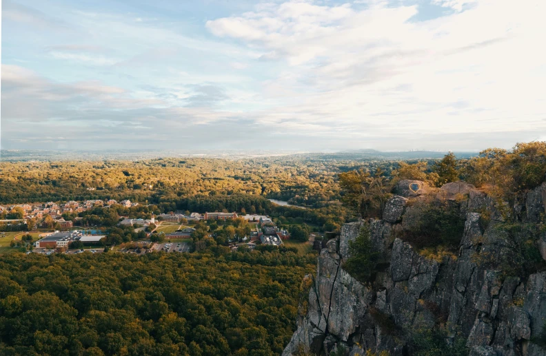 a view of a city from the top of a mountain, craigville, landscape photo, rocky cliff, golden hour photo