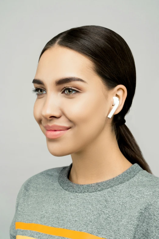 a woman with ear buds in her ears, trending on pexels, on grey background, tech demo, side front view, square
