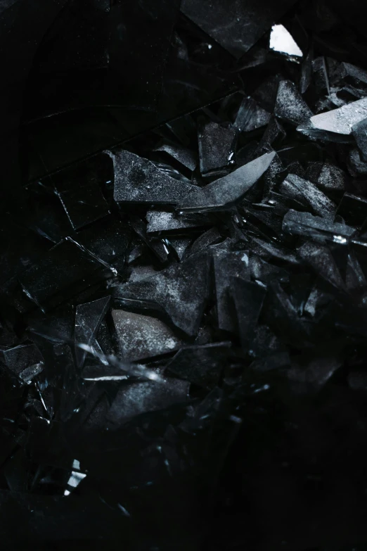 a pile of broken glass sitting on top of a table, an album cover, by Adam Marczyński, pexels contest winner, crystal cubism, high resolution coal texture, panel of black, black, made of ice