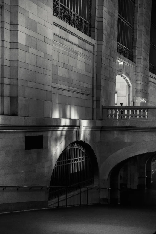 a black and white photo of a train station, inspired by Alfred Eisenstaedt, unsplash contest winner, white stone arches, glowing light and shadow, the met museum, evening at dusk