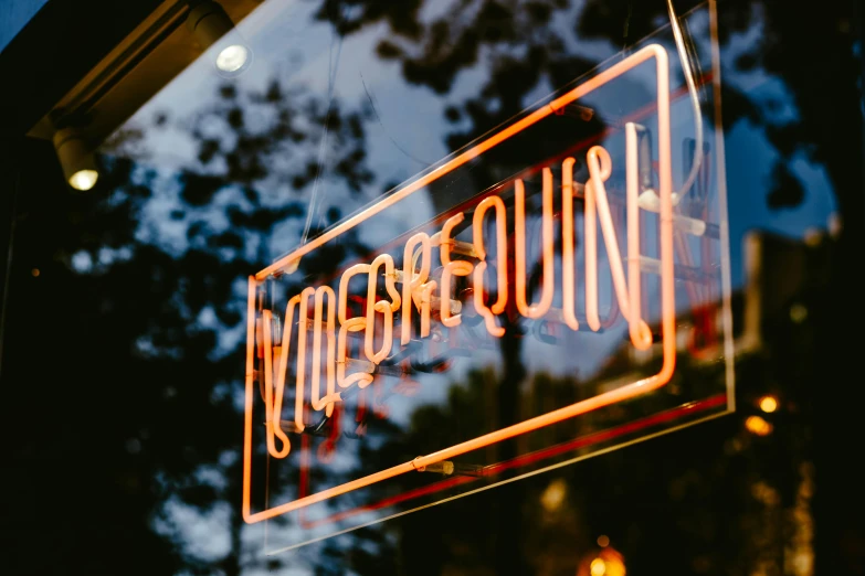 a neon sign hanging from the side of a building, a hologram, by Niko Henrichon, trending on unsplash, epicurious, vogue photo, goosebumps, outside a saloon
