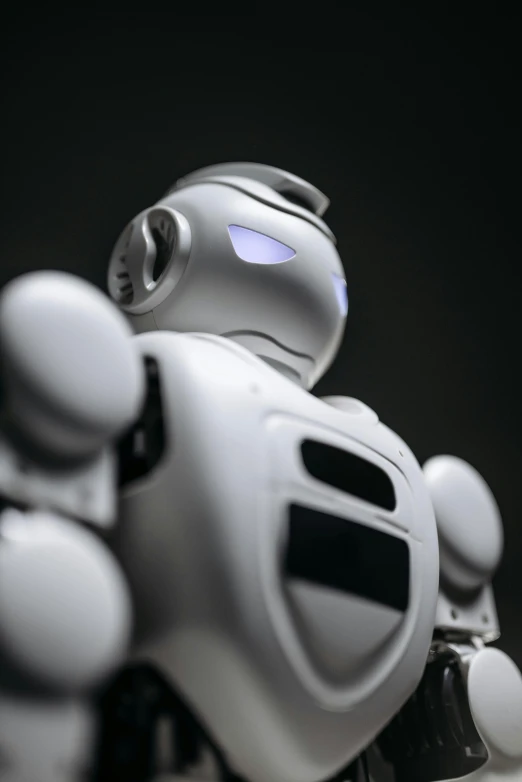 a close up of a robot on a table, trending on reddit, on black background, wikipedia, centered shot, on a gray background