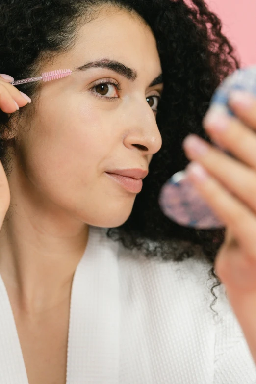 a woman brushes her hair in front of a mirror, trending on pexels, renaissance, relaxed eyebrows, candy treatments, thumbnail, blue