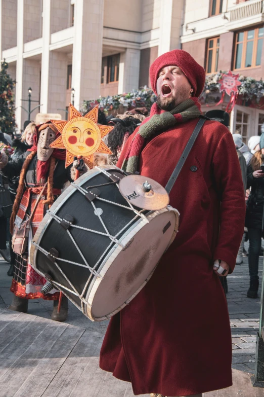 a man in a red outfit playing a drum, pexels contest winner, renaissance, in moscow centre, derp, hindu, christmas